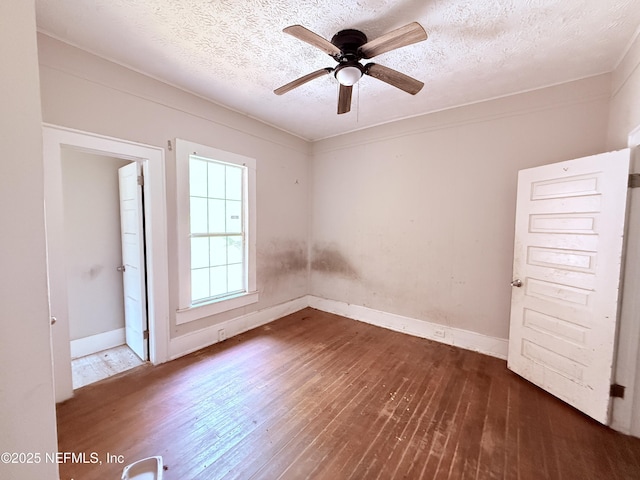 2771 Sunnyside St, Jacksonville, FL 32254 - empty room featuring dark wood-type flooring, ceiling fan, a textured ceiling, and baseboards