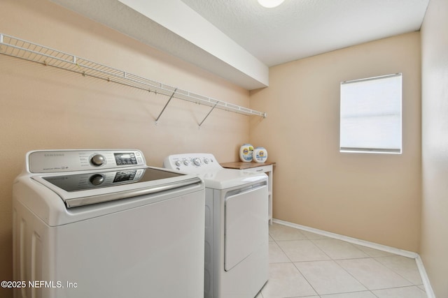 116 Nunna Rock Trl, Saint Augustine, FL 32092 - washroom featuring washing machine and clothes dryer, baseboards, and light tile patterned floors