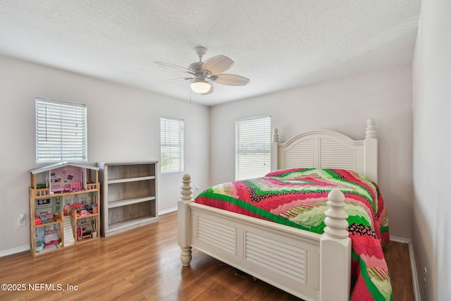 116 Nunna Rock Trl, Saint Augustine, FL 32092 - bedroom featuring wood finished floors, a textured ceiling, baseboards, and ceiling fan