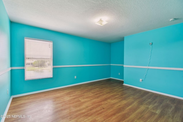 116 Nunna Rock Trl, Saint Augustine, FL 32092 - spare room featuring wood finished floors, a textured ceiling, and baseboards