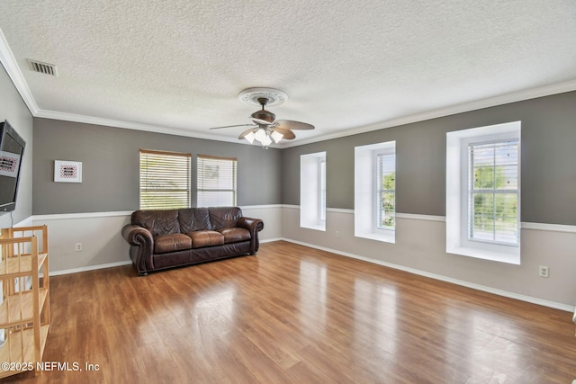 116 Nunna Rock Trl, Saint Augustine, FL 32092 - living room with wood finished floors, ornamental molding, plenty of natural light, ceiling fan, and a textured ceiling