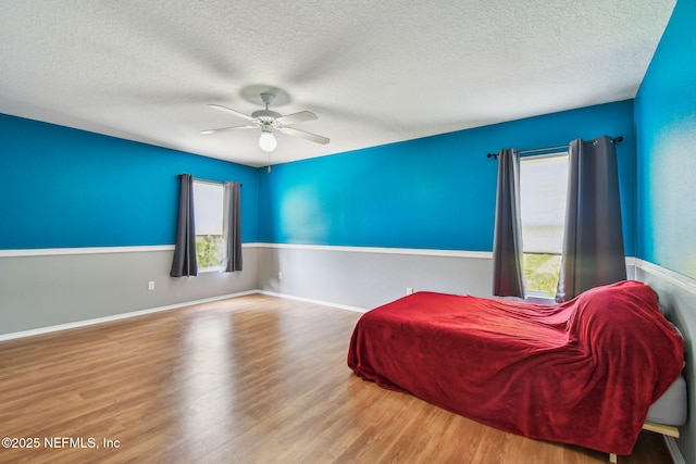116 Nunna Rock Trl, Saint Augustine, FL 32092 - bedroom with a textured ceiling, wood finished floors, and a ceiling fan
