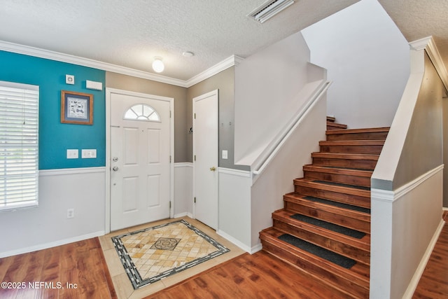 116 Nunna Rock Trl, Saint Augustine, FL 32092 - entryway with a textured ceiling, wood finished floors, stairway, baseboards, and ornamental molding