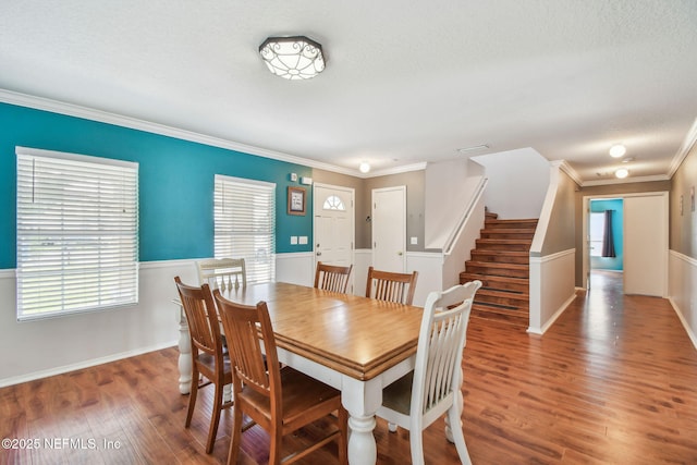 116 Nunna Rock Trl, Saint Augustine, FL 32092 - dining area featuring wood finished floors, ornamental molding, stairway, a textured ceiling, and baseboards