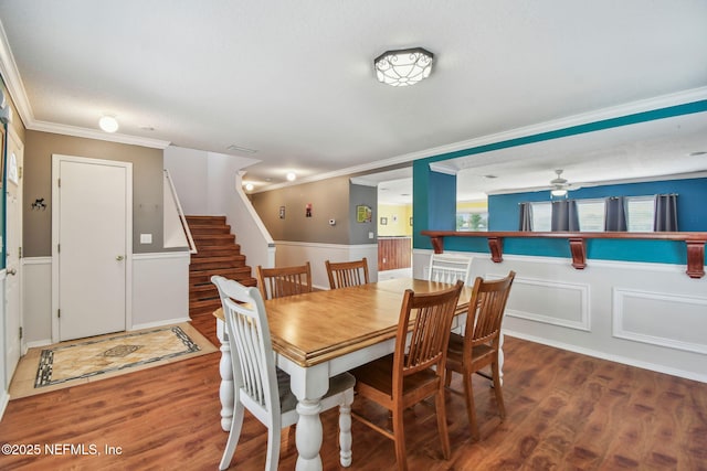 116 Nunna Rock Trl, Saint Augustine, FL 32092 - dining space featuring wainscoting, wood finished floors, stairs, ornamental molding, and a ceiling fan