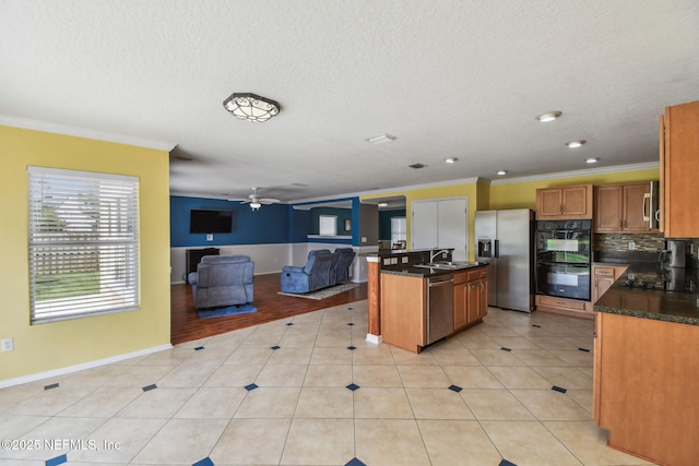 116 Nunna Rock Trl, Saint Augustine, FL 32092 - kitchen with black appliances, open floor plan, ornamental molding, brown cabinetry, and ceiling fan