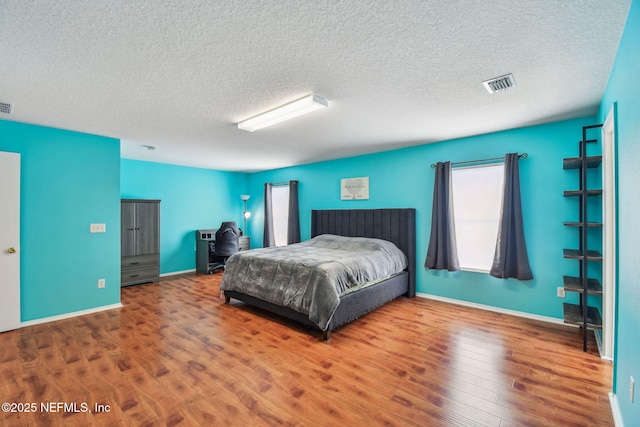 116 Nunna Rock Trl, Saint Augustine, FL 32092 - bedroom with wood finished floors, a textured ceiling, and baseboards