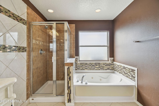 116 Nunna Rock Trl, Saint Augustine, FL 32092 - full bath with a jetted tub, a stall shower, tile patterned floors, a textured ceiling, and a textured wall