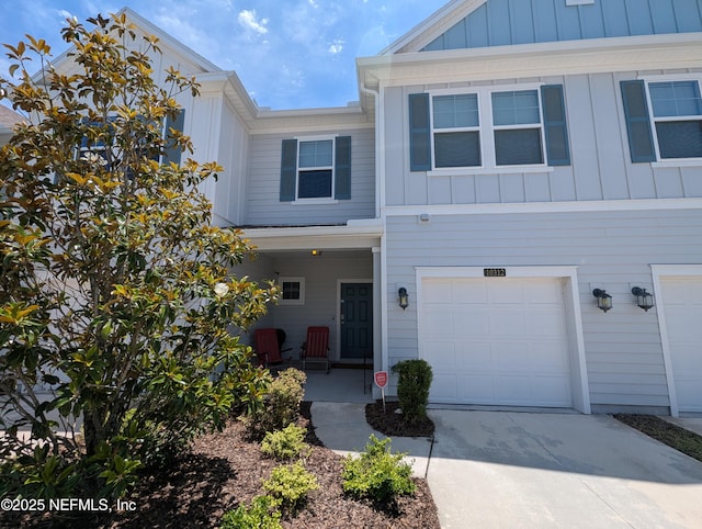 10312 Benson Lake Dr, Jacksonville, FL 32222 - view of front of property featuring board and batten siding, an attached garage, driveway, and a porch