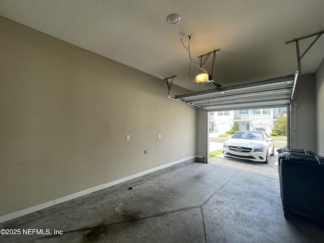10312 Benson Lake Dr, Jacksonville, FL 32222 - garage featuring baseboards and a garage door opener
