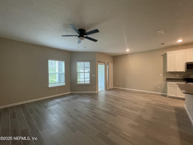 10312 Benson Lake Dr, Jacksonville, FL 32222 - unfurnished living room with a ceiling fan, baseboards, wood finished floors, and recessed lighting