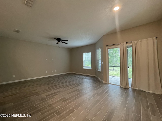 10312 Benson Lake Dr, Jacksonville, FL 32222 - spare room featuring baseboards, a ceiling fan, and dark wood-type flooring