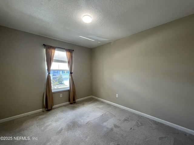10312 Benson Lake Dr, Jacksonville, FL 32222 - carpeted spare room featuring a textured ceiling and baseboards