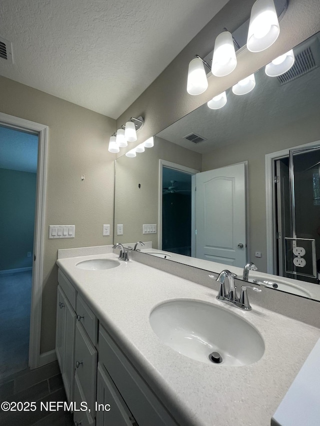 10312 Benson Lake Dr, Jacksonville, FL 32222 - bathroom with double vanity and a textured ceiling