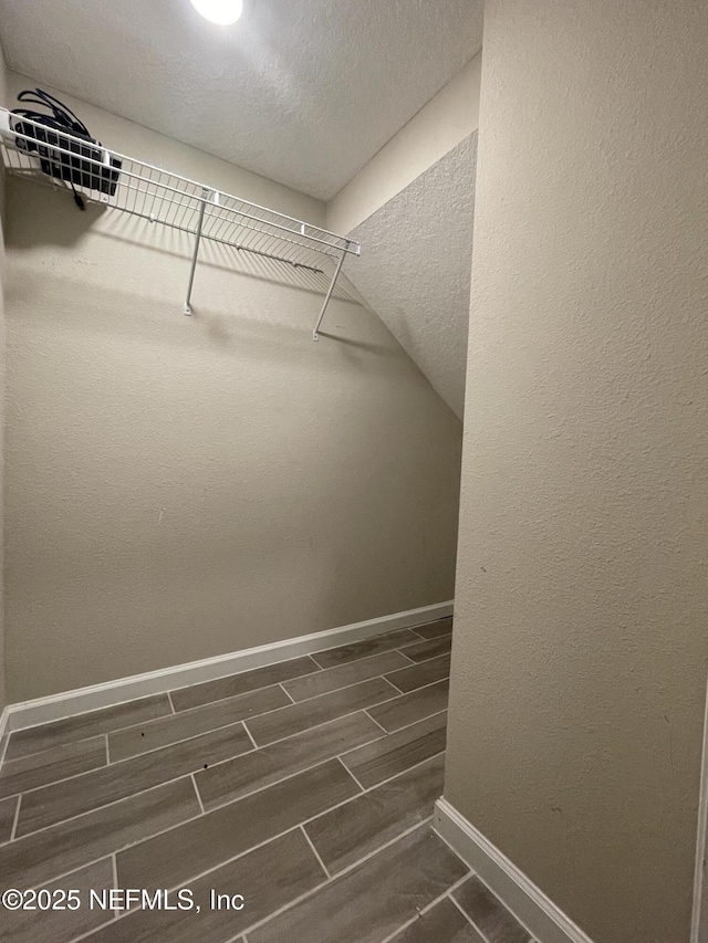 10312 Benson Lake Dr, Jacksonville, FL 32222 - walk in closet featuring lofted ceiling and dark wood-type flooring