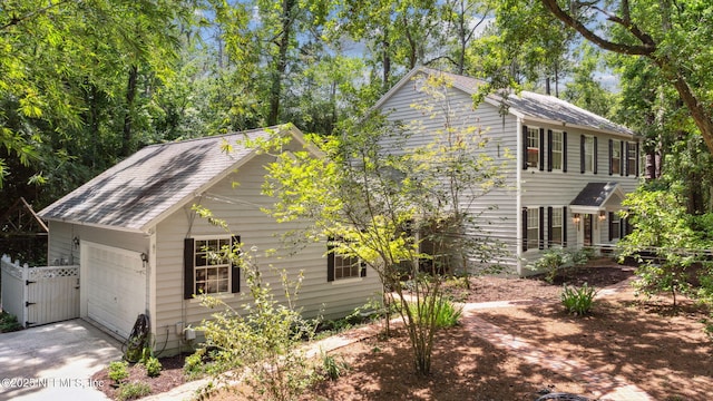 2153 Mills Rd, Jacksonville, FL 32216 - view of property exterior with a gate, concrete driveway, and a garage