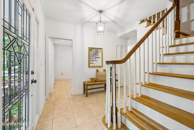 2153 Mills Rd, Jacksonville, FL 32216 - foyer entrance with stairs, light tile patterned floors, crown molding, and baseboards