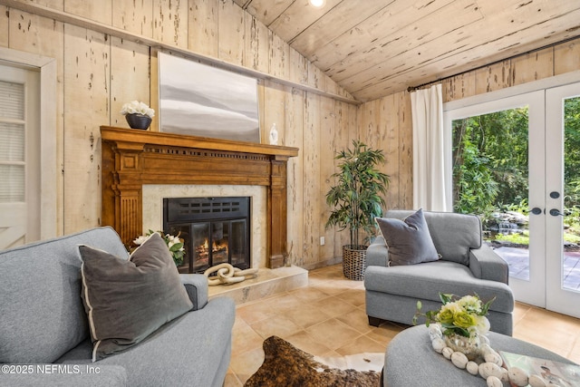2153 Mills Rd, Jacksonville, FL 32216 - tiled living room featuring lofted ceiling, wooden walls, wood ceiling, a high end fireplace, and french doors