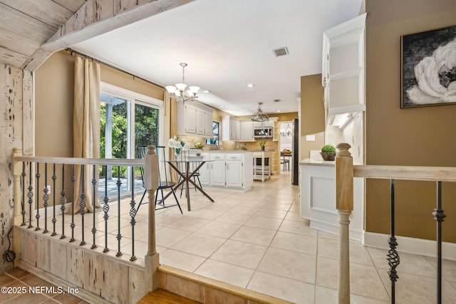2153 Mills Rd, Jacksonville, FL 32216 - kitchen with light tile patterned flooring, light countertops, a chandelier, decorative backsplash, and recessed lighting