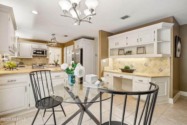 2153 Mills Rd, Jacksonville, FL 32216 - kitchen with a chandelier, open shelves, stainless steel appliances, white cabinets, and recessed lighting
