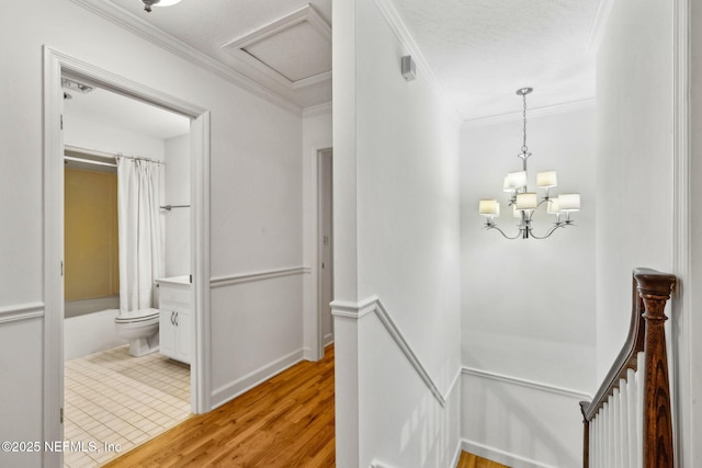 2153 Mills Rd, Jacksonville, FL 32216 - hallway with an upstairs landing, wood finished floors, crown molding, a chandelier, and baseboards