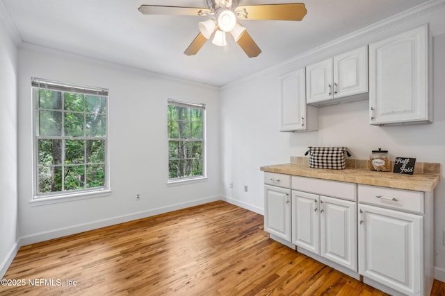 2153 Mills Rd, Jacksonville, FL 32216 - kitchen featuring light wood-style floors, healthy amount of natural light, ornamental molding, and baseboards