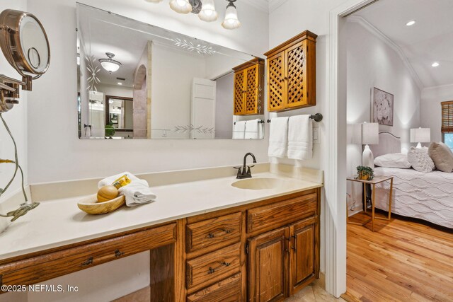 2153 Mills Rd, Jacksonville, FL 32216 - bathroom featuring crown molding, wood finished floors, vanity, and recessed lighting