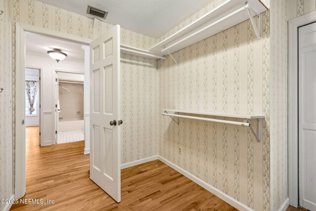 2153 Mills Rd, Jacksonville, FL 32216 - walk in closet featuring wood finished floors