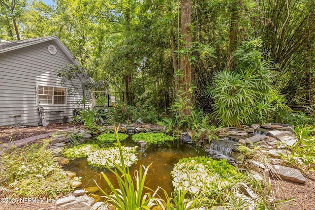 2153 Mills Rd, Jacksonville, FL 32216 - view of yard with a garden pond