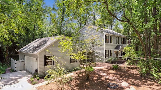 2153 Mills Rd, Jacksonville, FL 32216 - view of front of property with concrete driveway, an attached garage, and a gate
