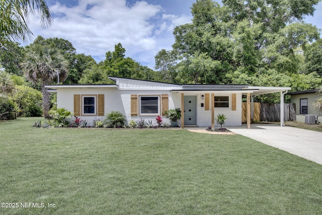 3904 Peach Dr, Jacksonville, FL 32246 - view of front of house with driveway, central AC unit, a carport, and stucco siding