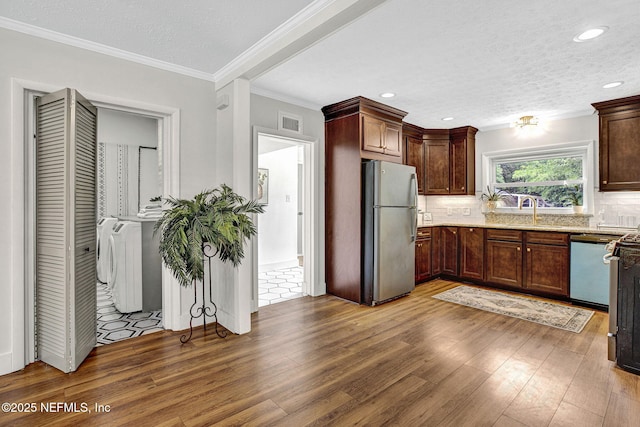 3904 Peach Dr, Jacksonville, FL 32246 - kitchen featuring freestanding refrigerator, wood finished floors, dishwasher, crown molding, and a sink