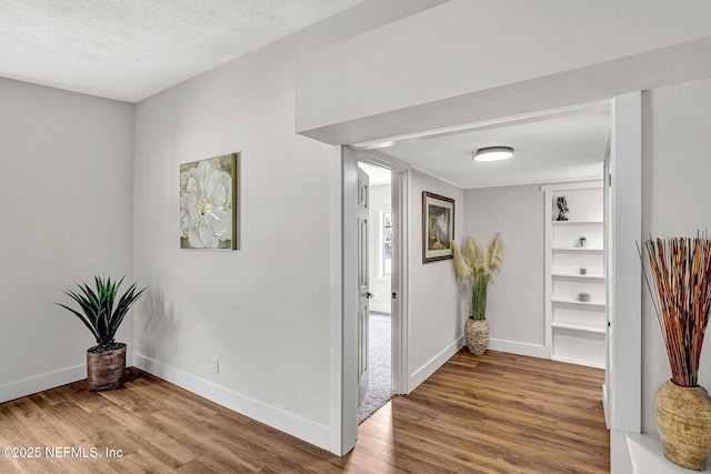 3904 Peach Dr, Jacksonville, FL 32246 - hallway with wood finished floors, baseboards, and a textured ceiling
