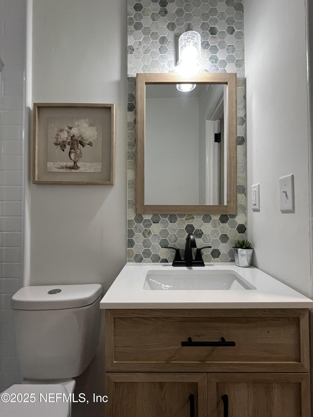 3904 Peach Dr, Jacksonville, FL 32246 - bathroom featuring vanity, toilet, and tasteful backsplash