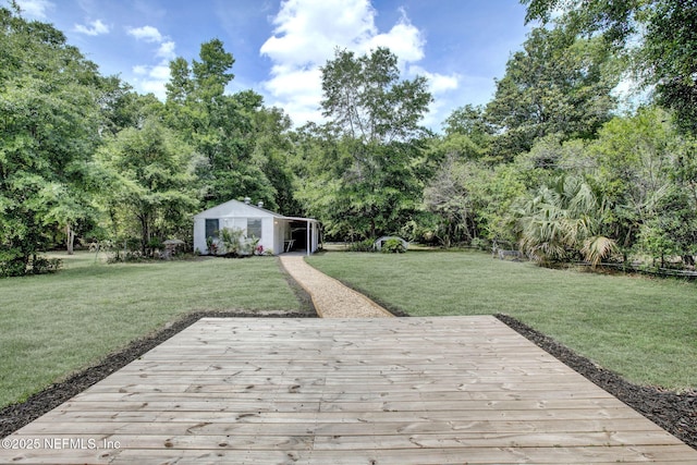 3904 Peach Dr, Jacksonville, FL 32246 - view of green lawn with a wooden deck, view of scattered trees, and an outbuilding