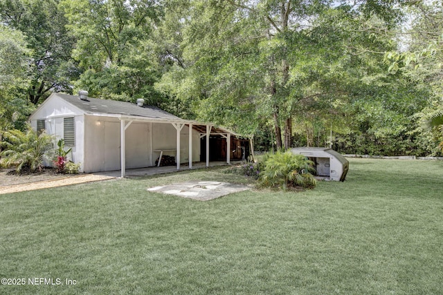 3904 Peach Dr, Jacksonville, FL 32246 - view of grassy yard with an outdoor structure and view of wooded area