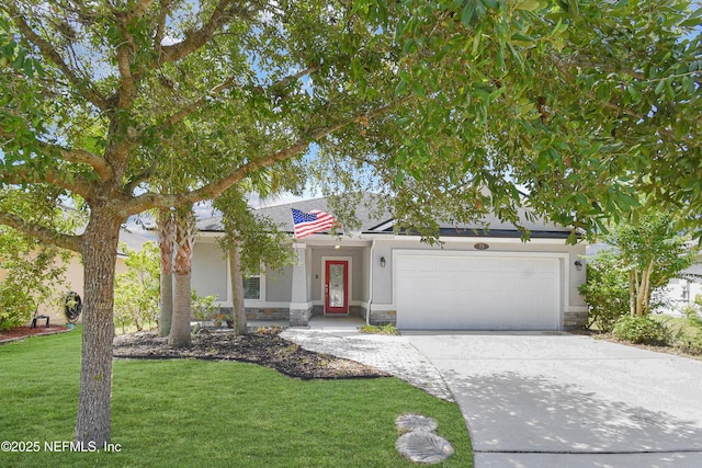 75 Codman Dr, Saint Augustine, FL 32084 - view of front of home with an attached garage, concrete driveway, stucco siding, a front yard, and stone siding