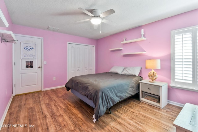 75 Codman Dr, Saint Augustine, FL 32084 - bedroom featuring light wood-type flooring, multiple windows, baseboards, and a textured ceiling