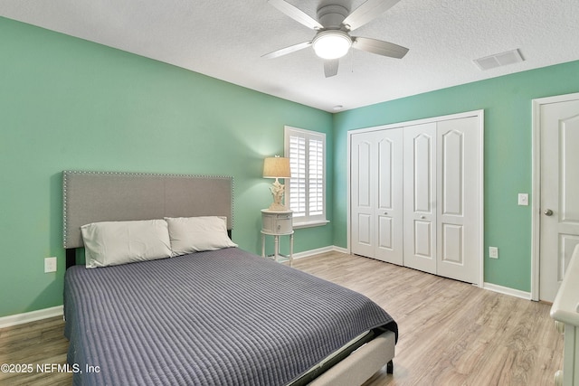 75 Codman Dr, Saint Augustine, FL 32084 - bedroom with wood finished floors, a closet, baseboards, and a textured ceiling