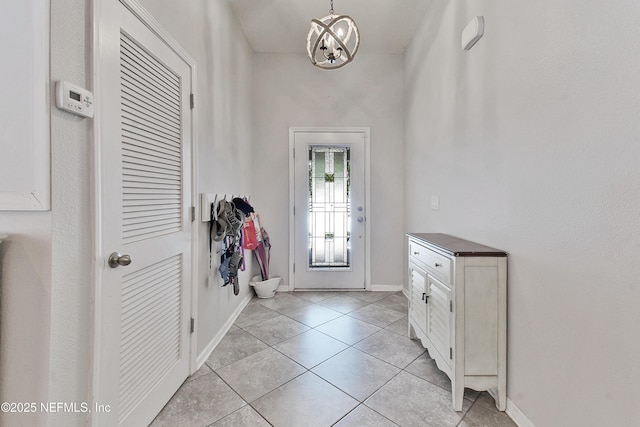 75 Codman Dr, Saint Augustine, FL 32084 - foyer entrance with light tile patterned floors, baseboards, and a chandelier