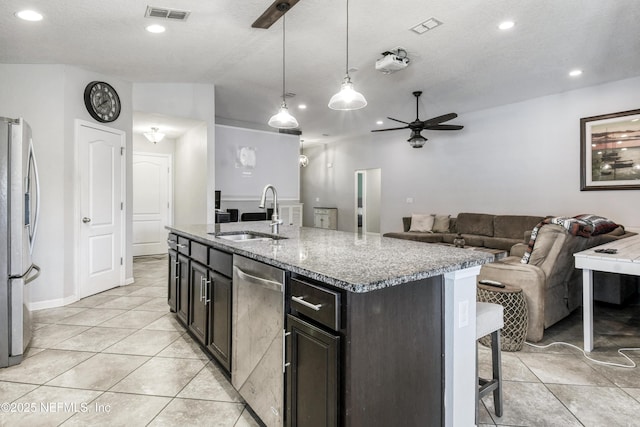 75 Codman Dr, Saint Augustine, FL 32084 - kitchen with a sink, appliances with stainless steel finishes, ceiling fan, light tile patterned flooring, and light stone counters