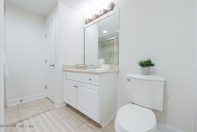 1201 1st St N Unit 1002, Jacksonville Beach, FL 32250 - full bathroom with vanity, toilet, tile patterned floors, baseboards, and a shower with shower door