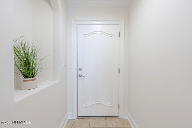 1201 1st St N Unit 1002, Jacksonville Beach, FL 32250 - doorway to outside with baseboards and light tile patterned floors