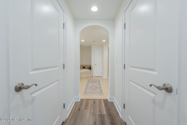 1201 1st St N Unit 1002, Jacksonville Beach, FL 32250 - corridor with arched walkways, wood finished floors, recessed lighting, and baseboards