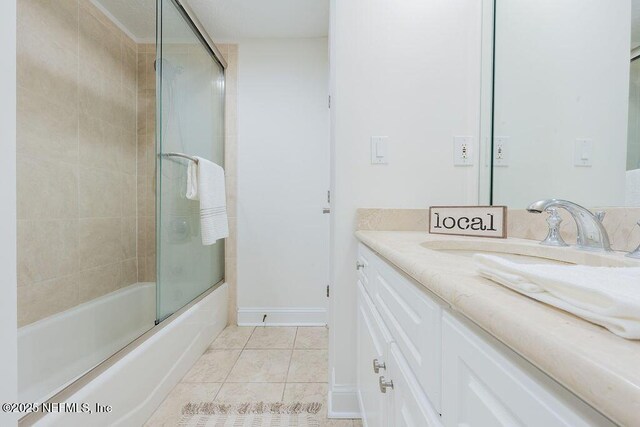 1201 1st St N Unit 1002, Jacksonville Beach, FL 32250 - bathroom with vanity, tile patterned floors, combined bath / shower with glass door, and baseboards