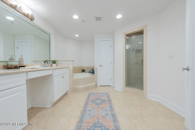1201 1st St N Unit 1002, Jacksonville Beach, FL 32250 - bathroom with vanity, a garden tub, a shower stall, recessed lighting, and tile patterned floors