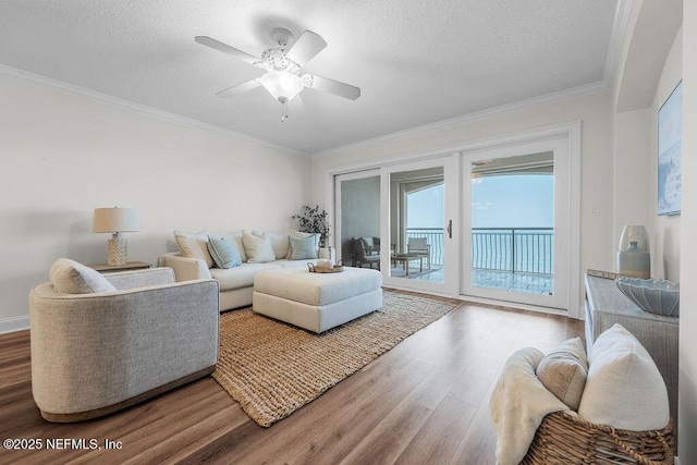 1201 1st St N Unit 1002, Jacksonville Beach, FL 32250 - living area featuring wood finished floors, ornamental molding, a ceiling fan, and a textured ceiling