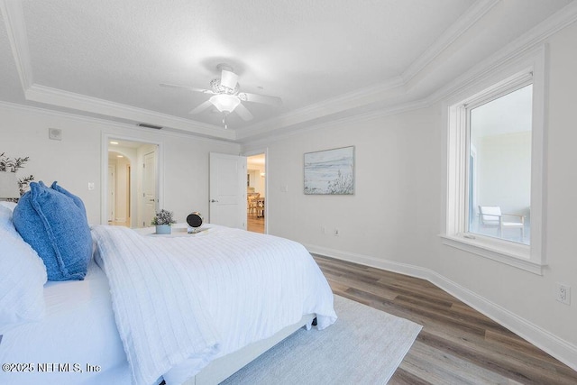 1201 1st St N Unit 1002, Jacksonville Beach, FL 32250 - bedroom featuring wood finished floors, ceiling fan, baseboards, crown molding, and a raised ceiling