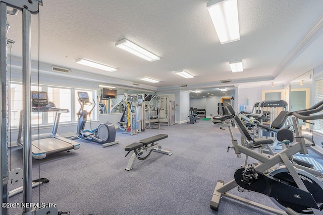 1201 1st St N Unit 1002, Jacksonville Beach, FL 32250 - workout area featuring a textured ceiling, baseboards, and crown molding