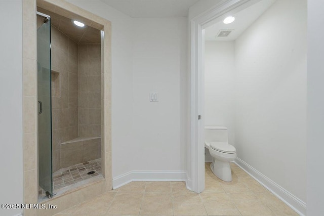 1201 1st St N Unit 1002, Jacksonville Beach, FL 32250 - full bath featuring a stall shower, toilet, baseboards, and tile patterned flooring